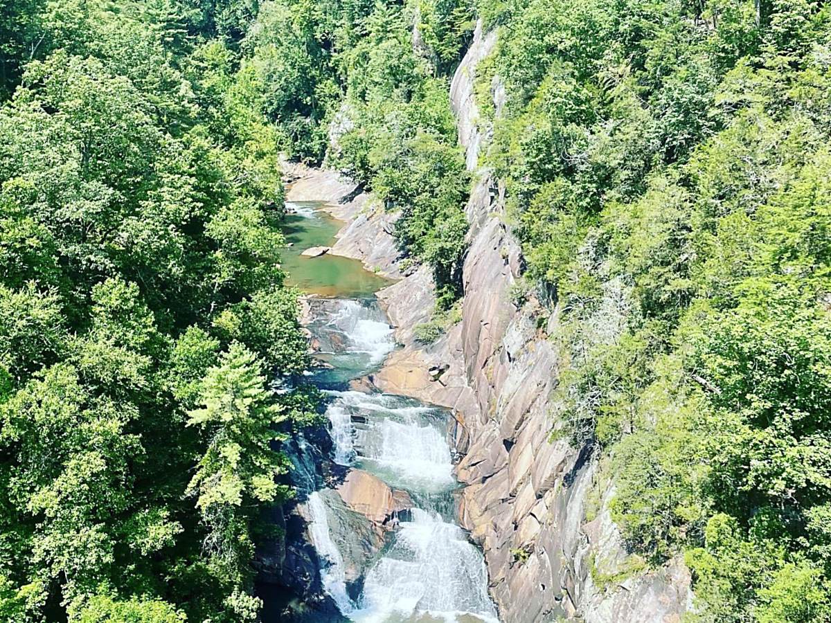 A river cutting through the forested North Georgia mountains, seen from above.